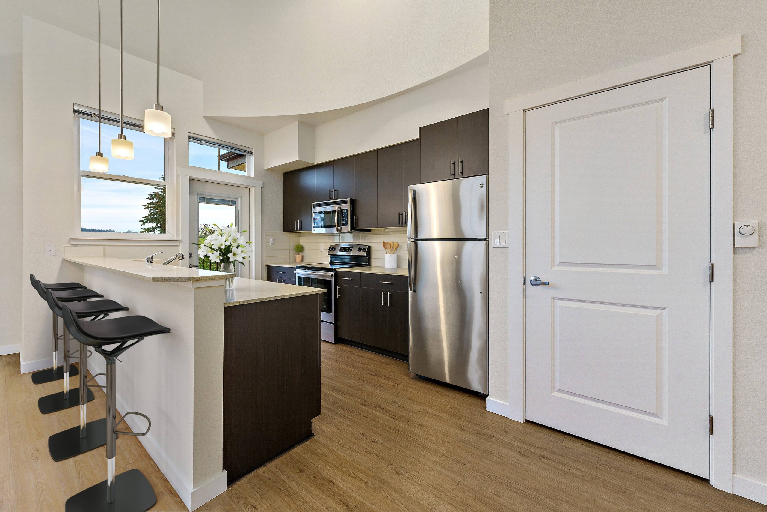 Kitchen island with bar seating and dark cabinets