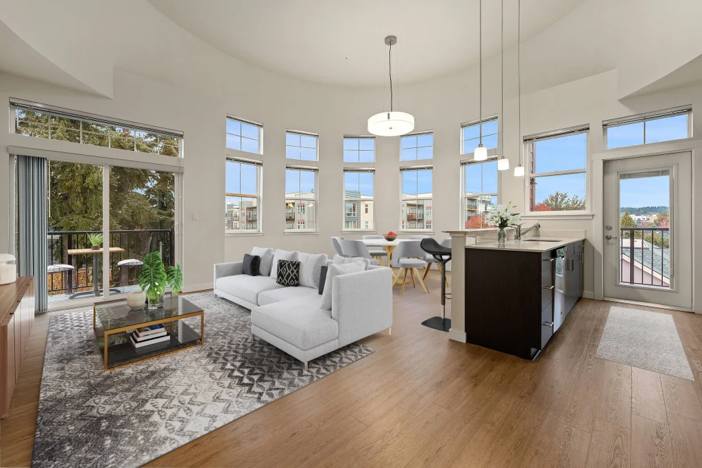 Living and kitchen area with a wall of windows